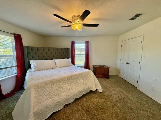 a bedroom with a bed and window