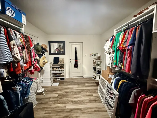 a view of walk in closet with clothes