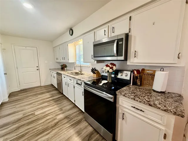 a kitchen with a sink stove and microwave