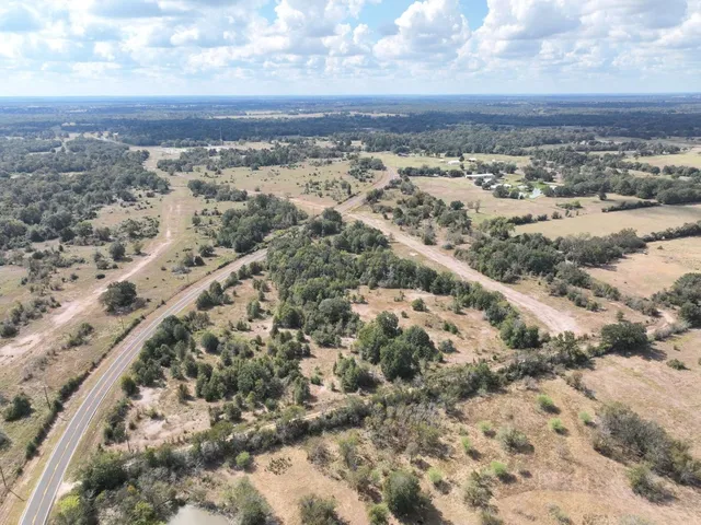 a view of a yard with wooden fence