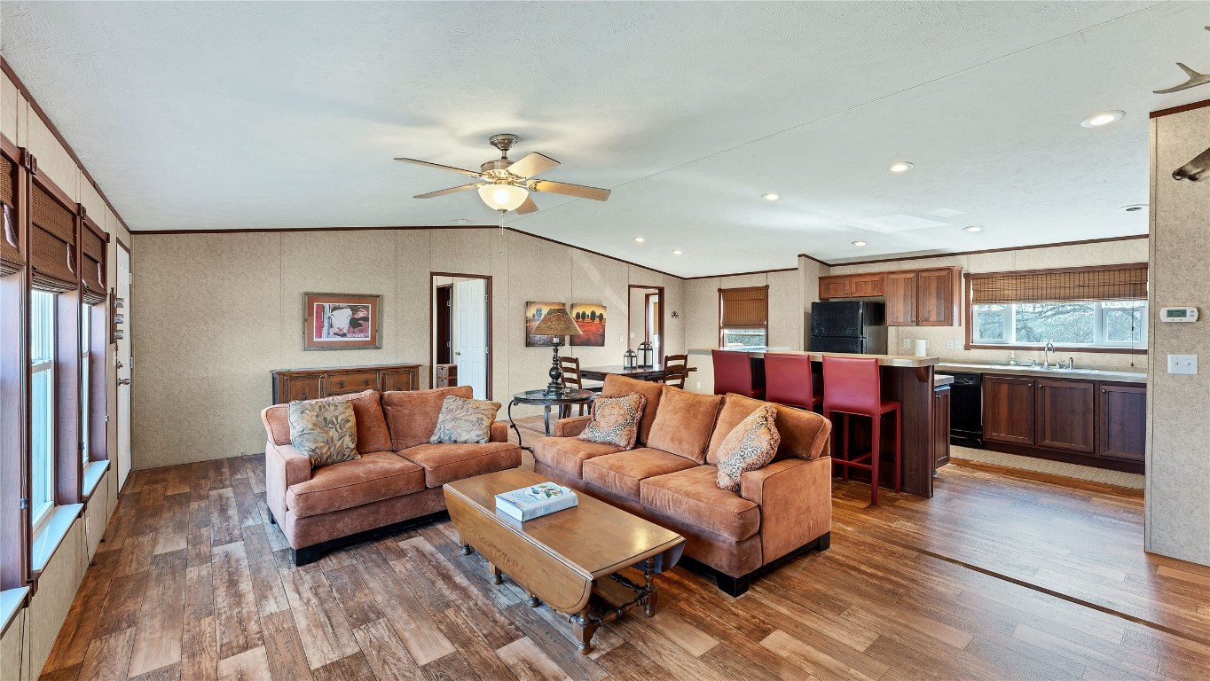 a living room with furniture and kitchen view