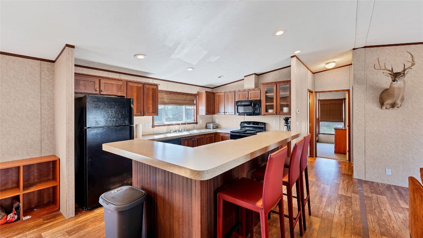 154 Cowboy Road Gonzales, TX 78629 - Photo 12 of 39 a kitchen that has a table chairs in it and wooden floors