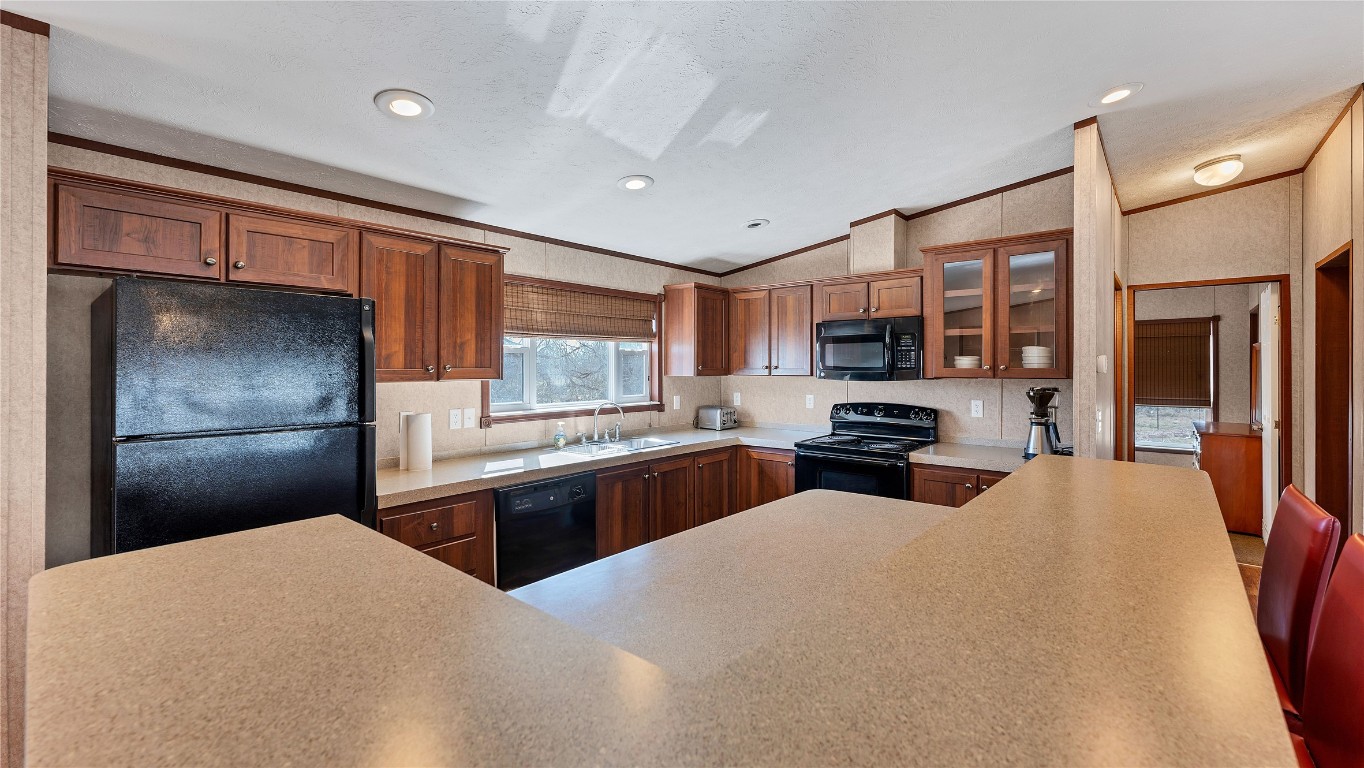 154 Cowboy Road Gonzales, TX 78629 - Photo 13 of 39 a kitchen with stainless steel appliances granite countertop a refrigerator stove microwave and sink