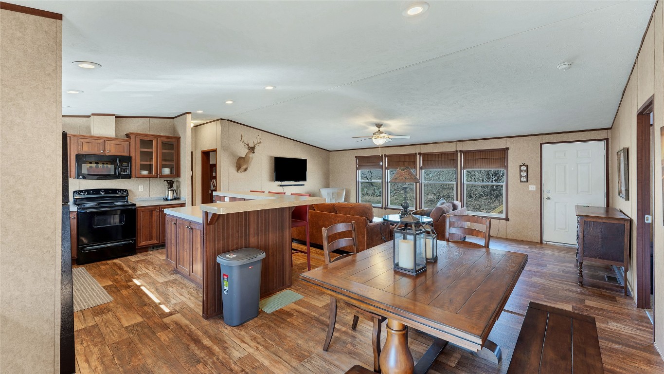 154 Cowboy Road Gonzales, TX 78629 - Photo 15 of 39 a kitchen with a table chairs and a wooden floor