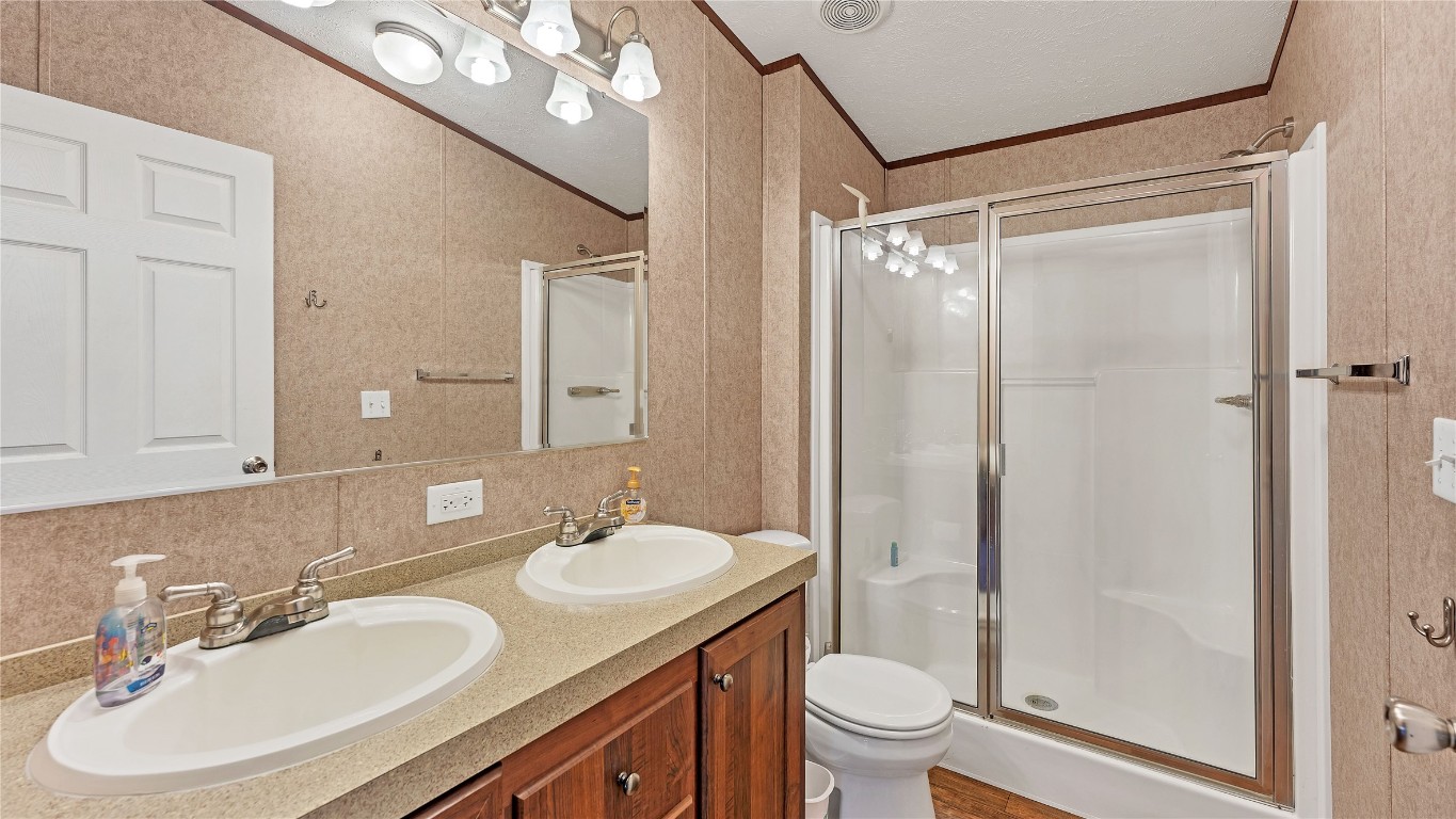 154 Cowboy Road Gonzales, TX 78629 - Photo 23 of 39 a bathroom with a granite countertop sink toilet and shower