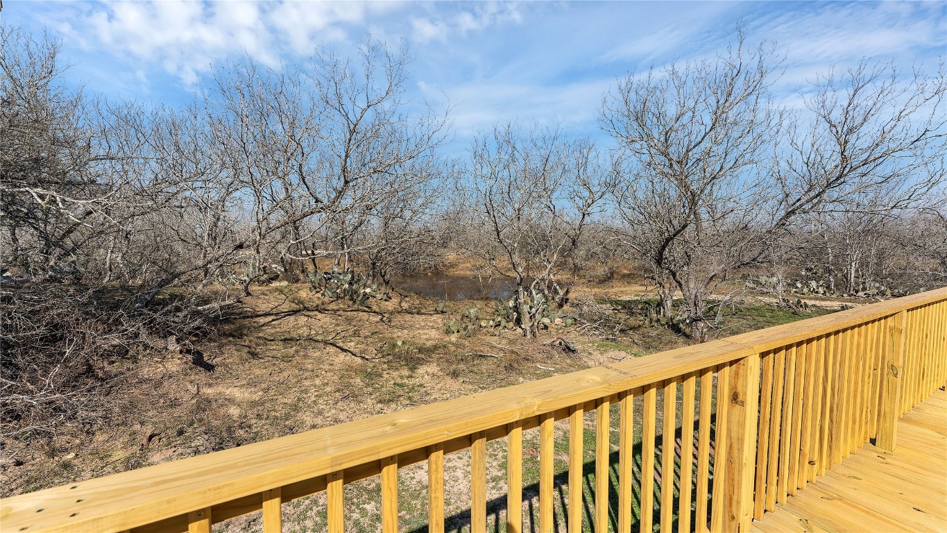 154 Cowboy Road Gonzales, TX 78629 - Photo 29 of 39 a view of a yard with wooden fence and trees