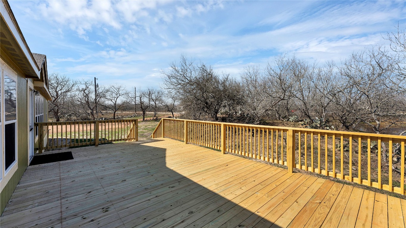 154 Cowboy Road Gonzales, TX 78629 - Photo 30 of 39 a view of deck with wooden floor and fence next to a yard