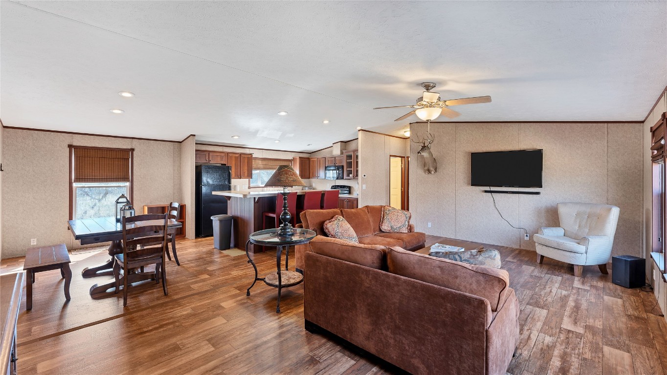 154 Cowboy Road Gonzales, TX 78629 - Photo 6 of 39 a living room with furniture a flat screen tv and kitchen view