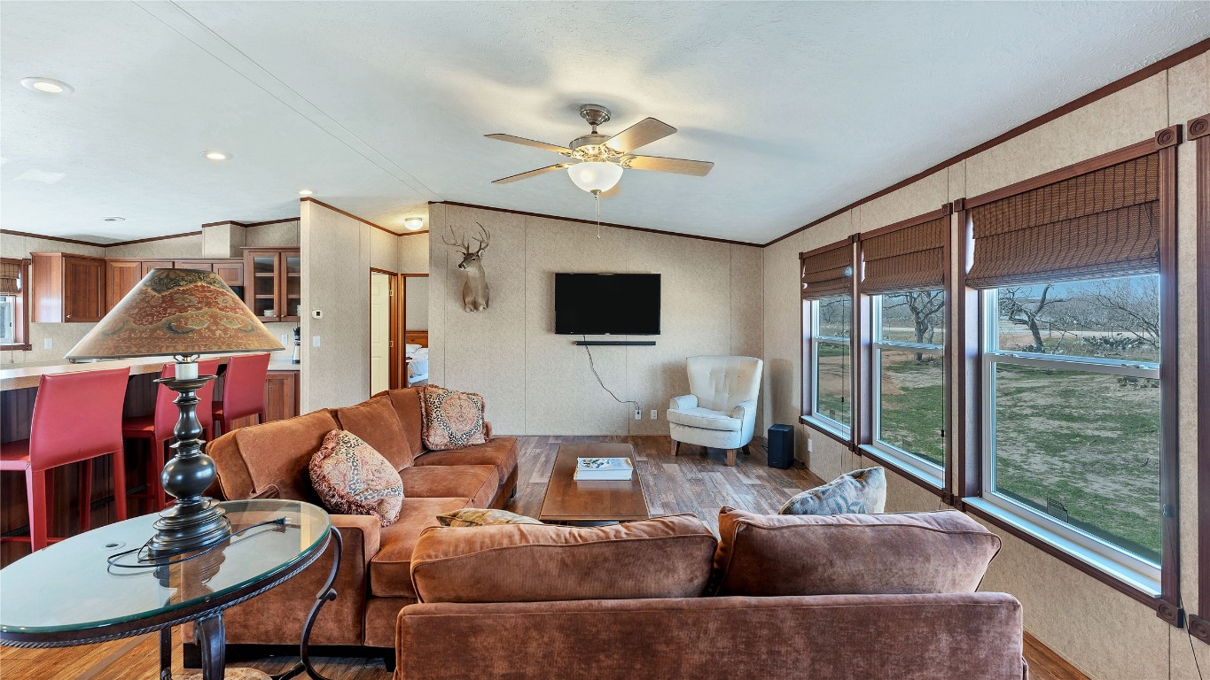 154 Cowboy Road Gonzales, TX 78629 - Photo 7 of 39 a living room with furniture a ceiling fan and a flat screen tv