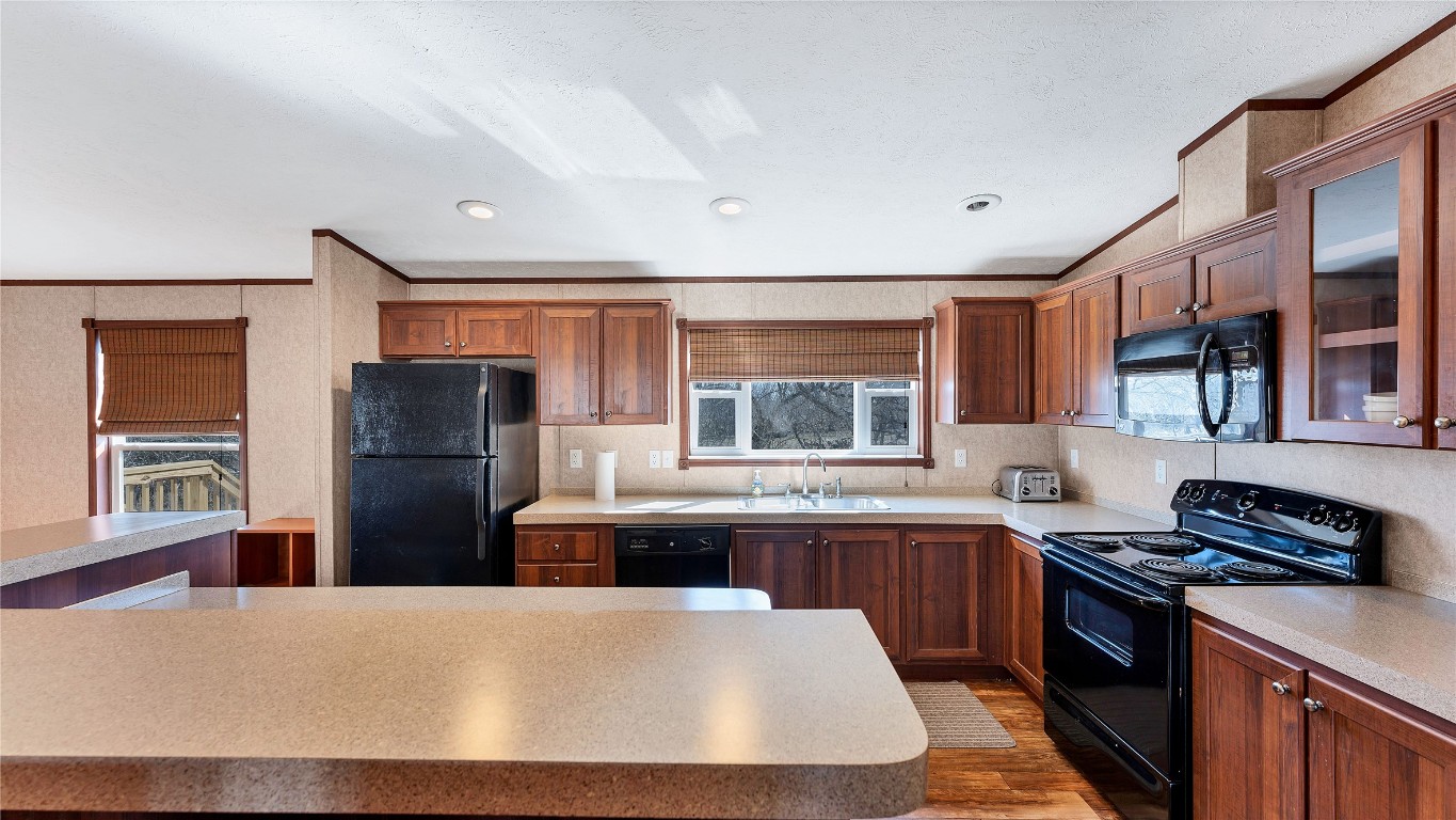 154 Cowboy Road Gonzales, TX 78629 - Photo 10 of 39 a kitchen with stainless steel appliances a refrigerator stove and sink