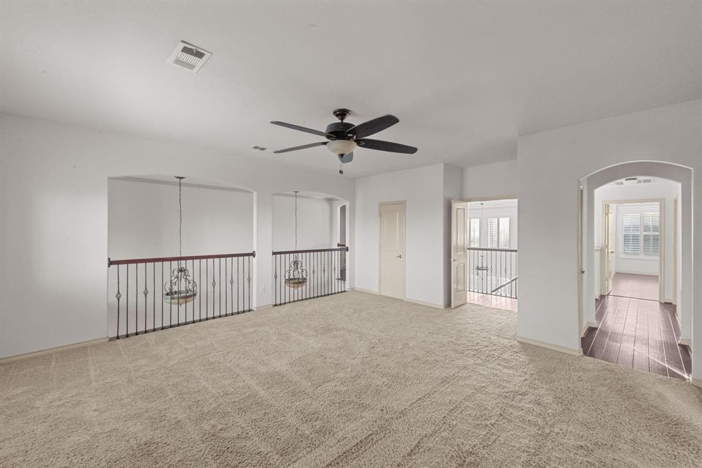 10001 Thurman Road Fort Worth, TX 76244 - Photo 11 of 18 a view of a livingroom with a ceiling fan & windows