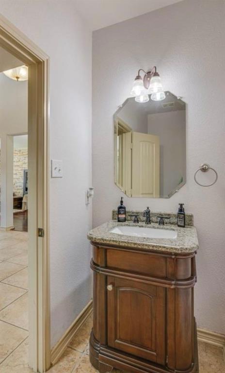 10001 Thurman Road Fort Worth, TX 76244 - Photo 16 of 18 a bathroom with a sink and a mirror