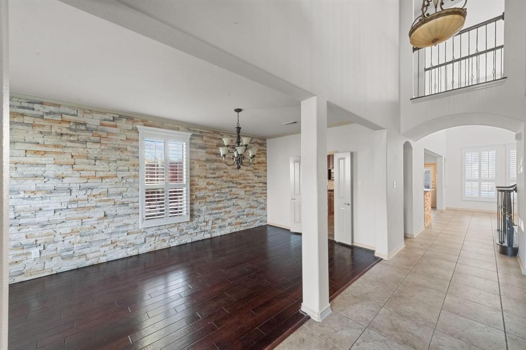 10001 Thurman Road Fort Worth, TX 76244 - Photo 6 of 18 an empty room with wooden floor and windows