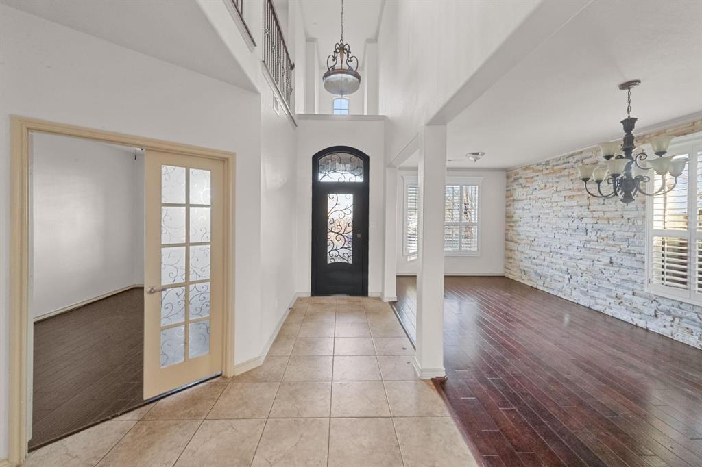 10001 Thurman Road Fort Worth, TX 76244 - Photo 7 of 18 wooden floor in an empty room with a window
