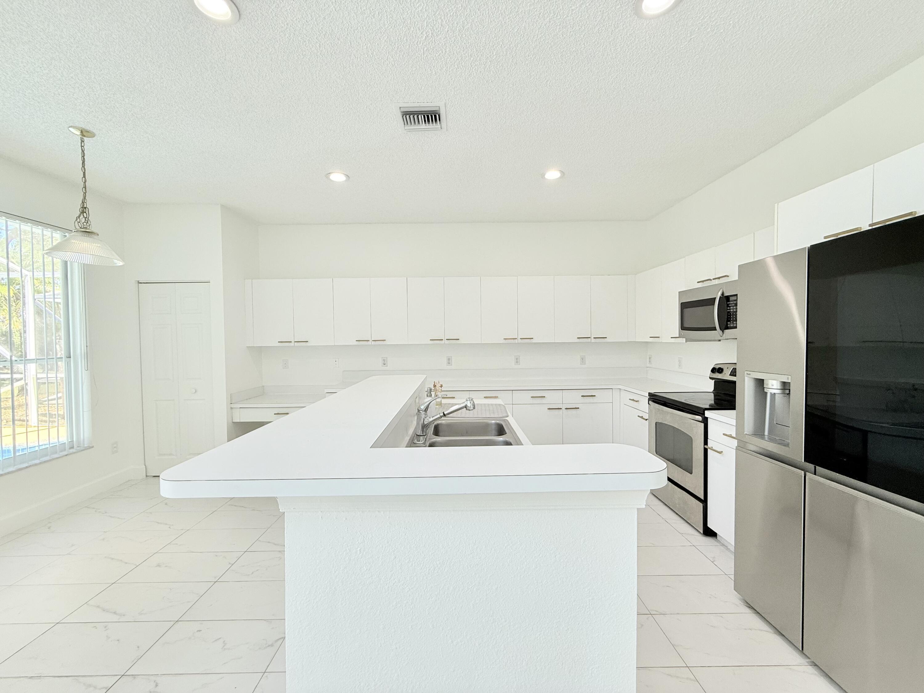 10875 Old Bridgeport Lane Boca Raton, FL 33498 - Photo 3 of 39 SPACIOUS KITCHEN + DINING AREA