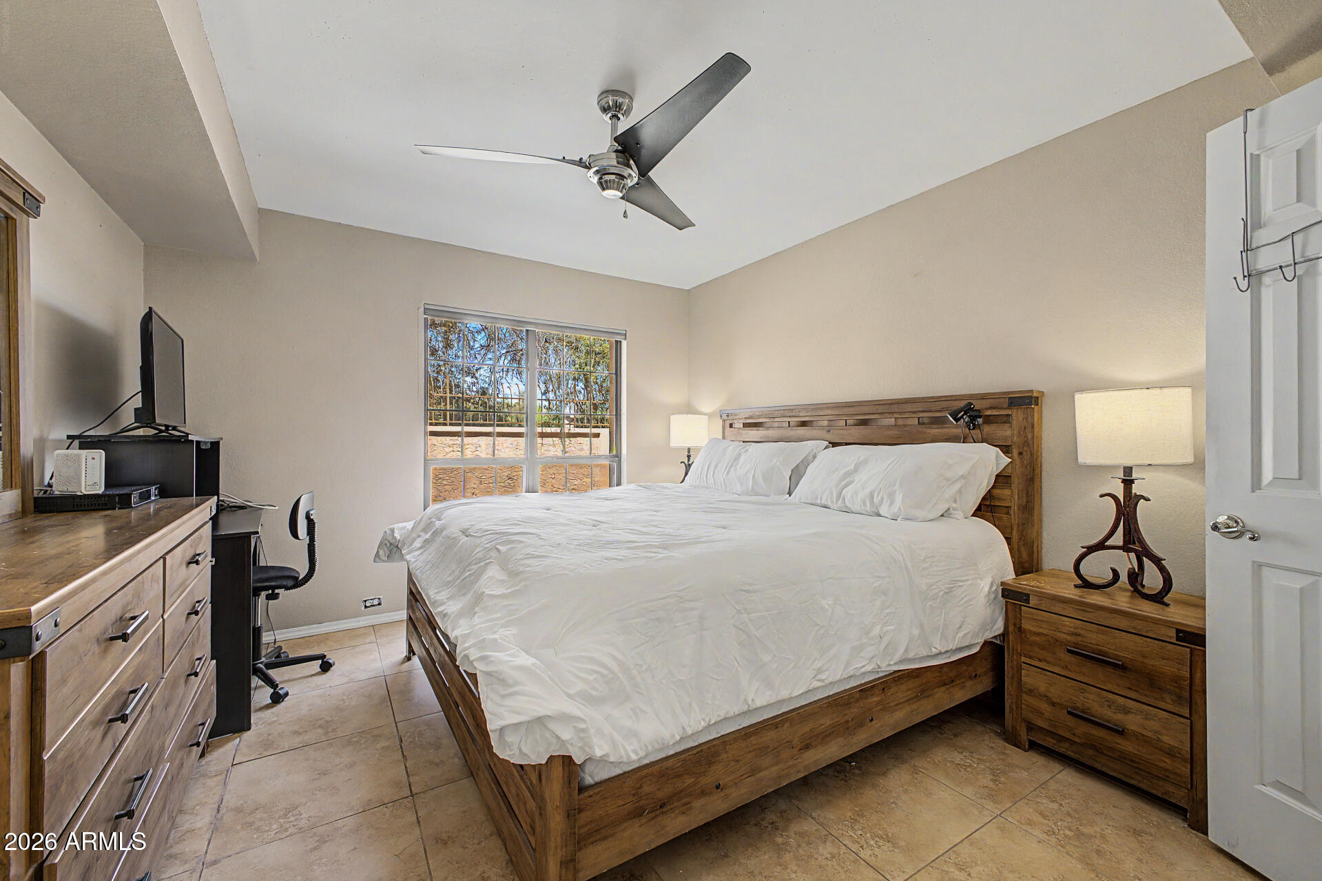 10410 North Cave Creek Road, Unit 1027 Phoenix, AZ 85020 - Photo 11 of 37 a bedroom with a bed and a flat tv screen on the dresser