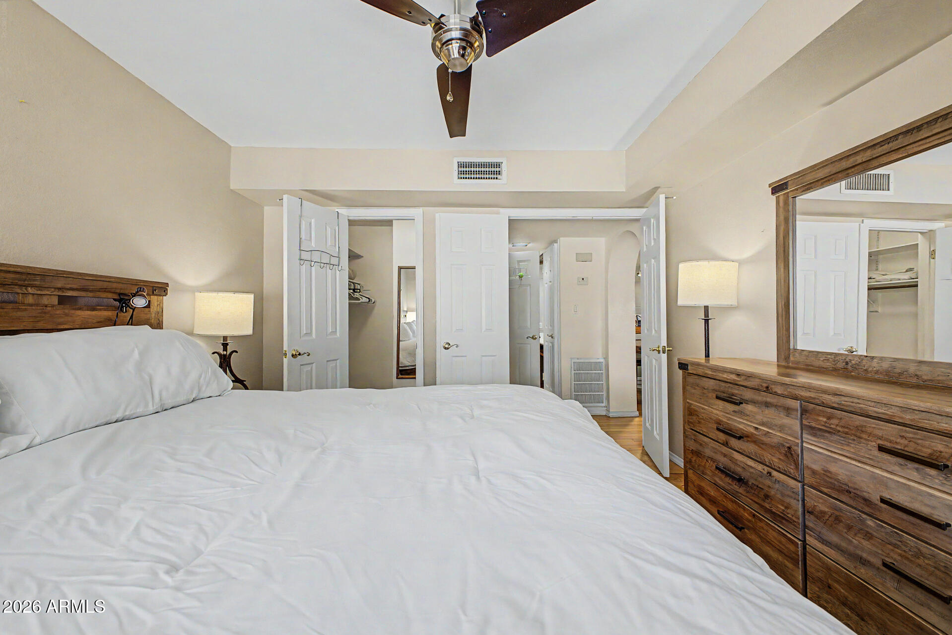 10410 North Cave Creek Road, Unit 1027 Phoenix, AZ 85020 - Photo 12 of 37 a bedroom with a large bed and wooden floor