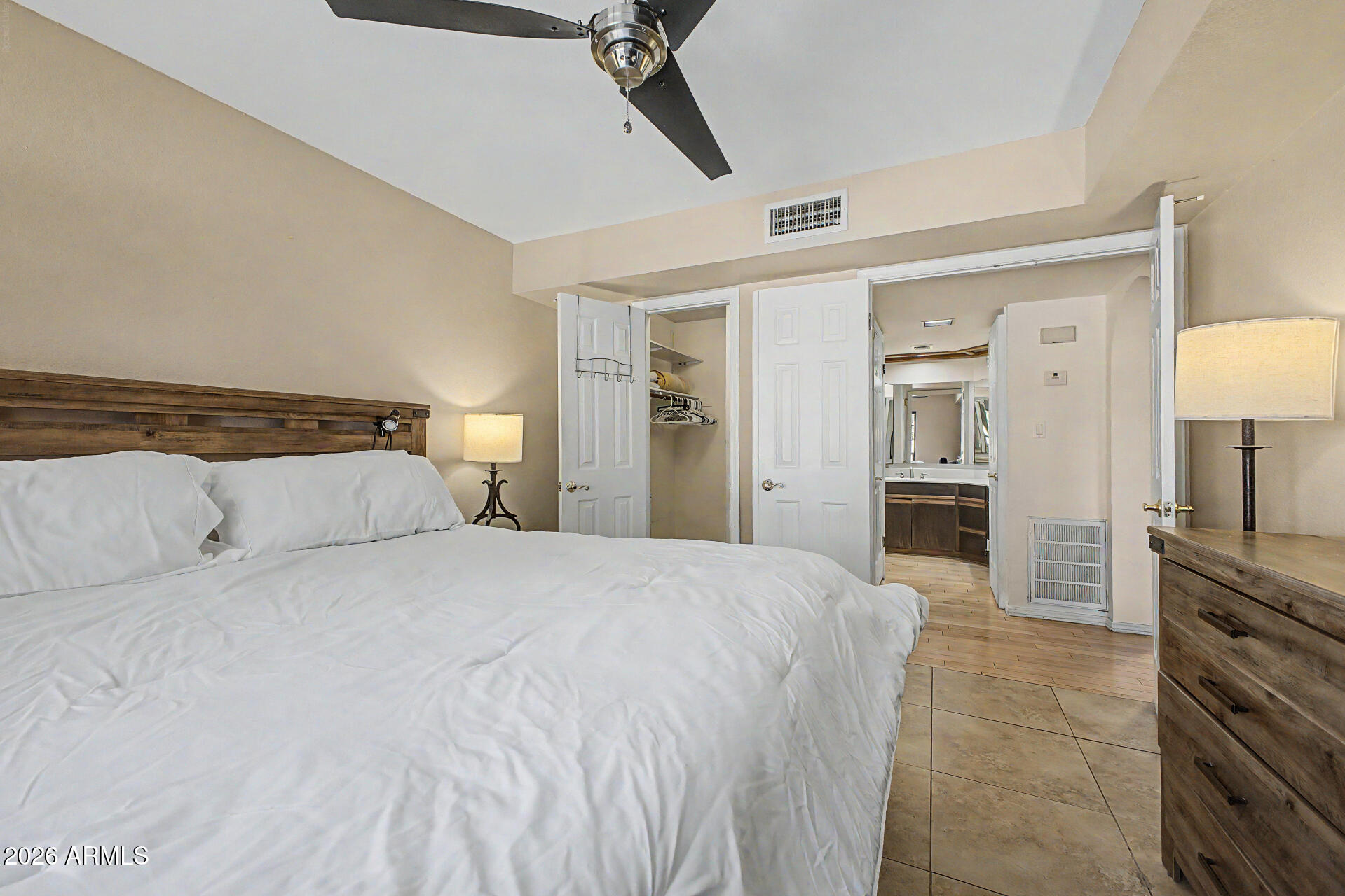 10410 North Cave Creek Road, Unit 1027 Phoenix, AZ 85020 - Photo 14 of 37 a large white bed in a white room