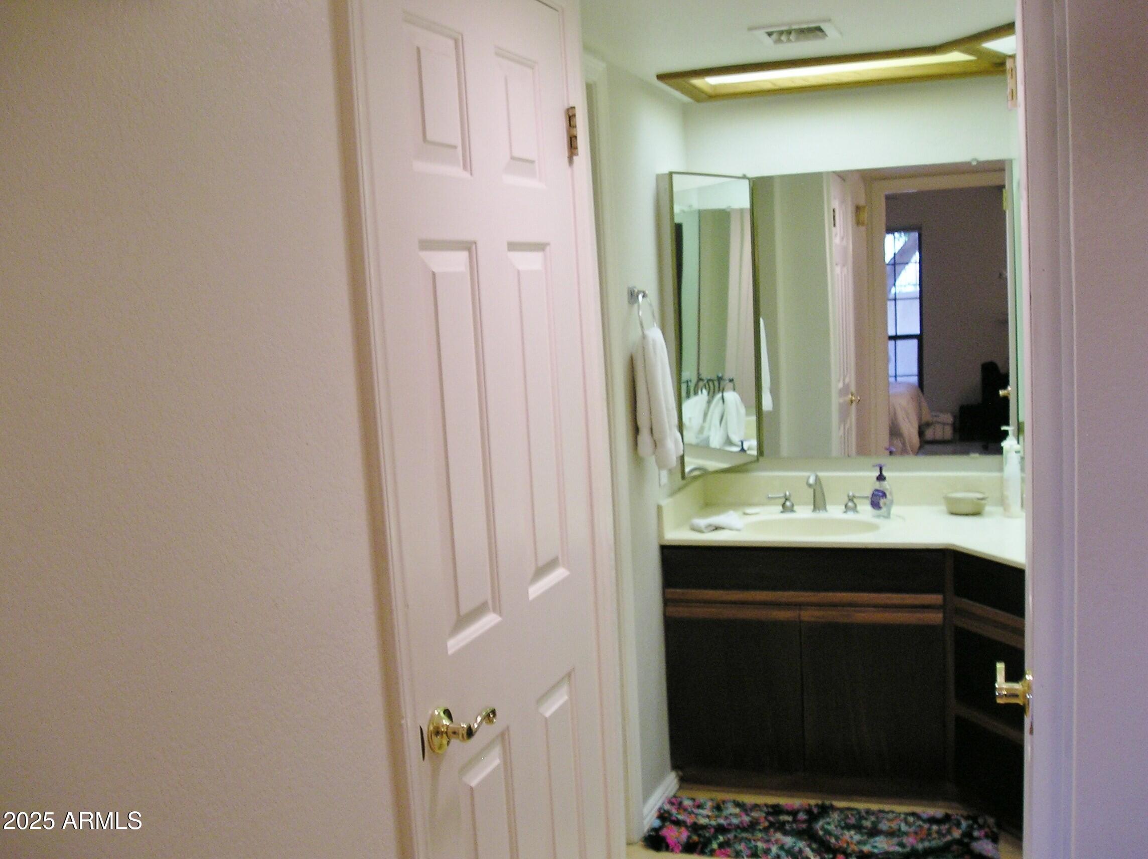 10410 North Cave Creek Road, Unit 1027 Phoenix, AZ 85020 - Photo 16 of 37 a bathroom with a sink and a mirror
