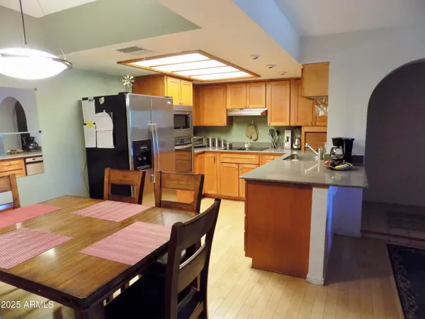 a kitchen with a table chairs and a refrigerator