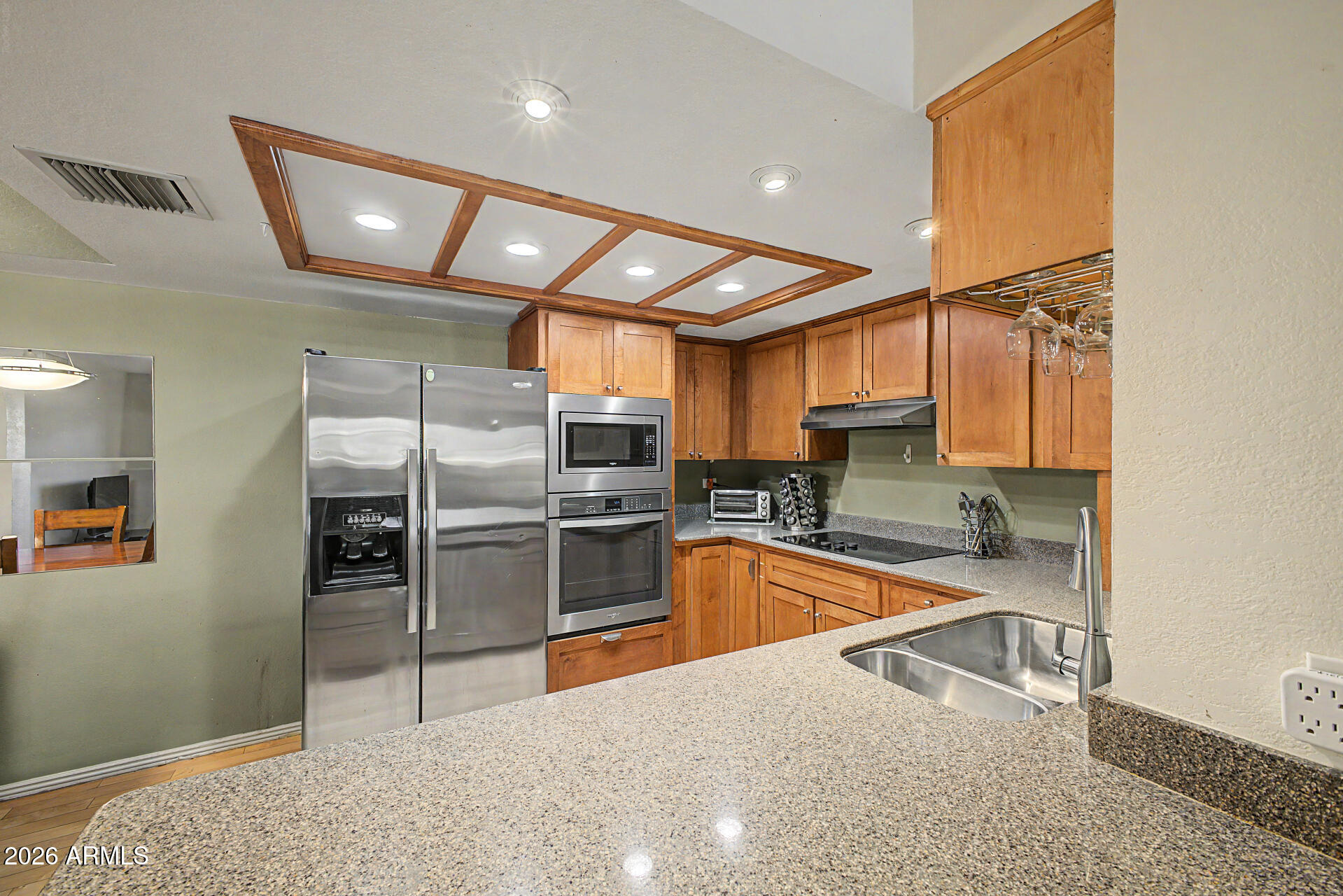 10410 North Cave Creek Road, Unit 1027 Phoenix, AZ 85020 - Photo 2 of 37 a kitchen with stainless steel appliances granite countertop a refrigerator and a sink
