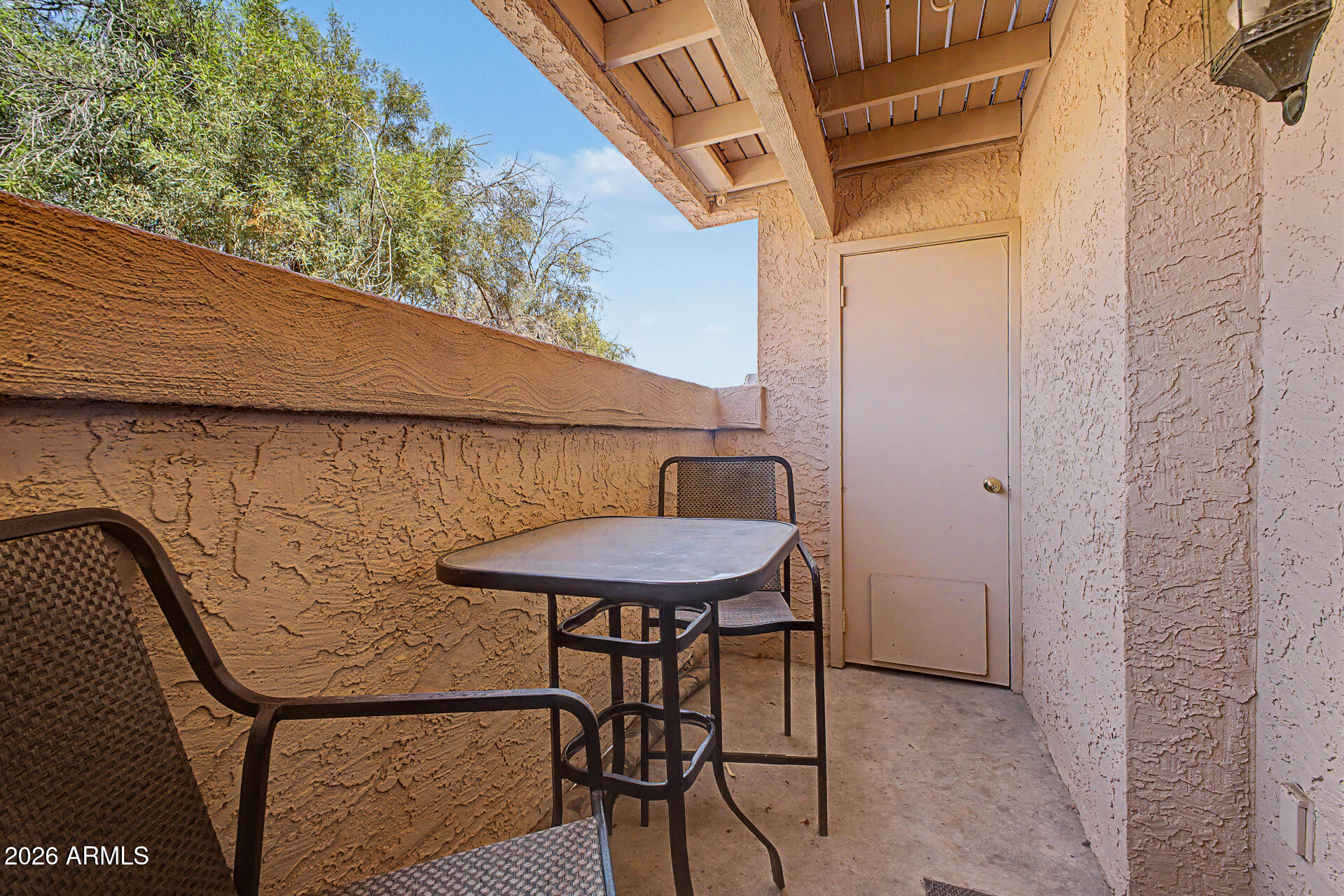 10410 North Cave Creek Road, Unit 1027 Phoenix, AZ 85020 - Photo 21 of 37 a balcony with table and chairs