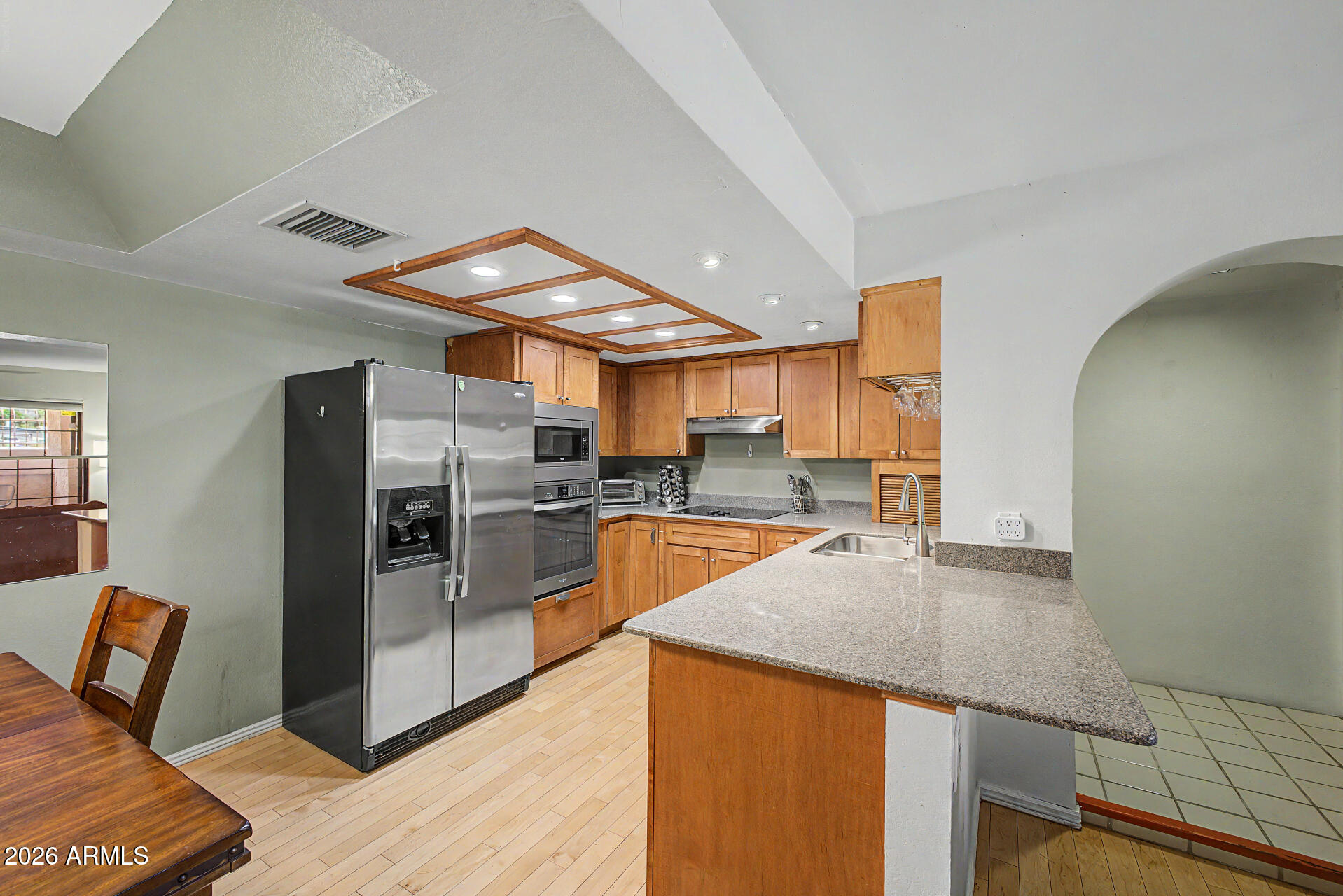 10410 North Cave Creek Road, Unit 1027 Phoenix, AZ 85020 - Photo 3 of 37 a kitchen with stainless steel appliances granite countertop a refrigerator a sink and a stove