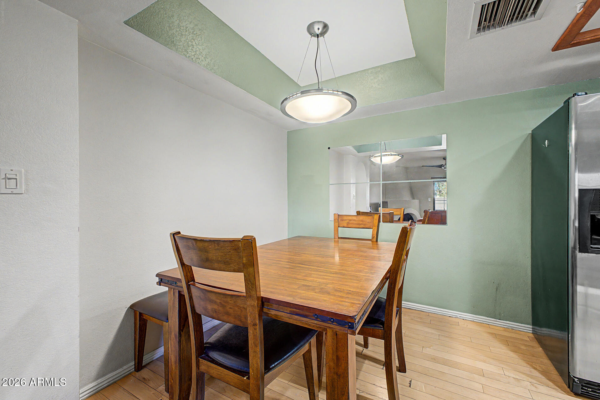 10410 North Cave Creek Road, Unit 1027 Phoenix, AZ 85020 - Photo 7 of 37 a view of a dining room with furniture and wooden floor