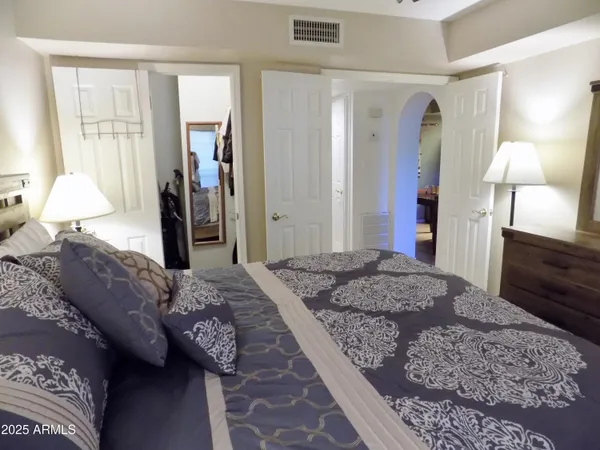 a bedroom with a bed and a dresser in it