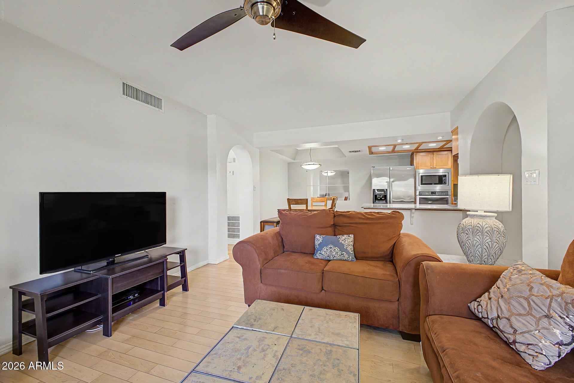 10410 North Cave Creek Road, Unit 1027 Phoenix, AZ 85020 - Photo 10 of 37 a living room with furniture and a flat screen tv