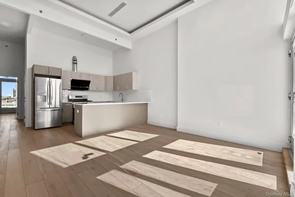 a kitchen with stainless steel appliances a refrigerator and a sink