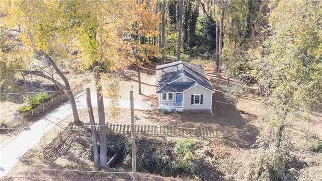 a view of a house with a yard covered in snow
