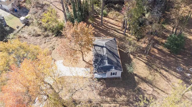 a backyard of a house with large trees
