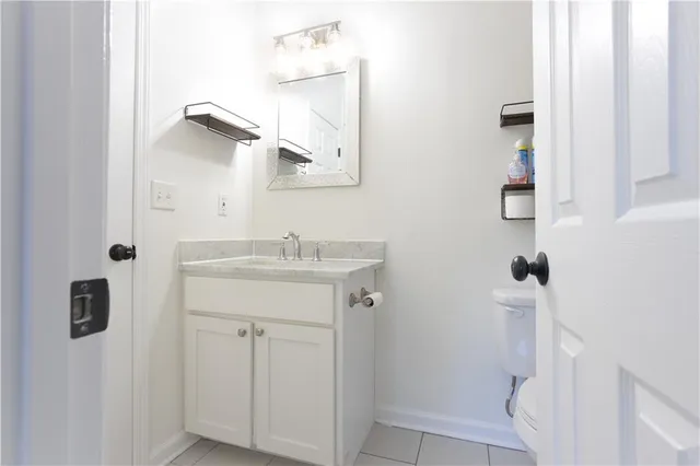 a bathroom with a sink a toilet and mirror