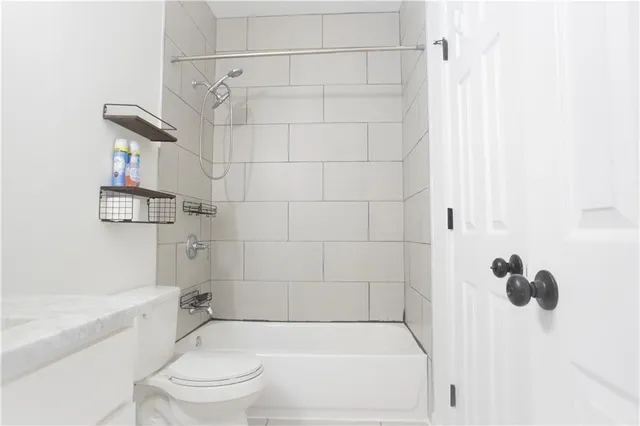a bathroom with a bathtub and shower
