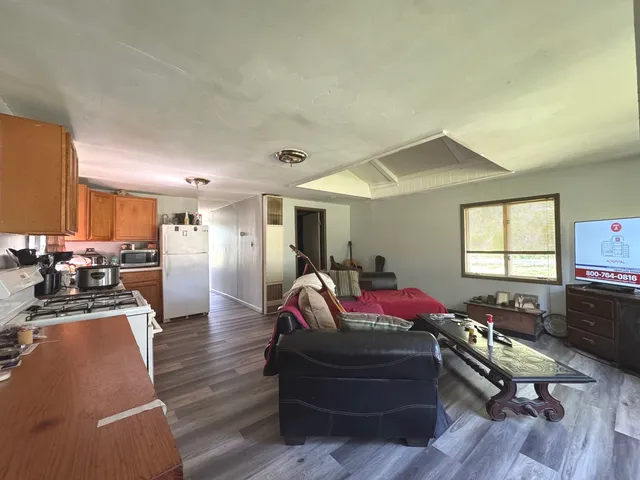 a living room with furniture window and wooden floor