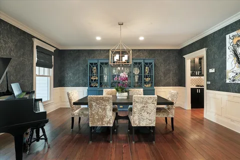 a view of a room with lots of wooden furniture and windows