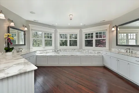 a bedroom with a bed furniture and a flat screen tv