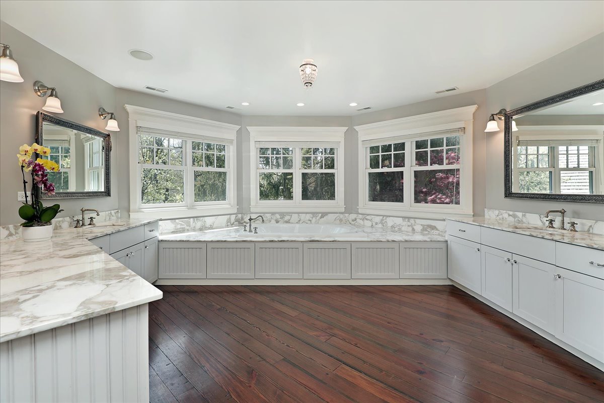 1423 Northwoods Road Deerfield, IL 60015 - Photo 17 of 39 a large white kitchen with granite countertop wooden floor sink and cabinets