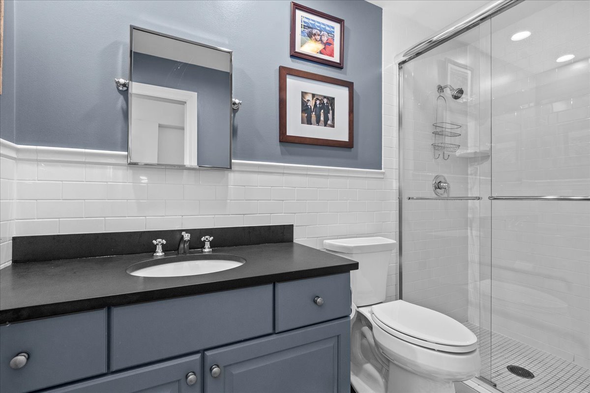 1423 Northwoods Road Deerfield, IL 60015 - Photo 22 of 39 a bathroom with a sink toilet a mirror and shower
