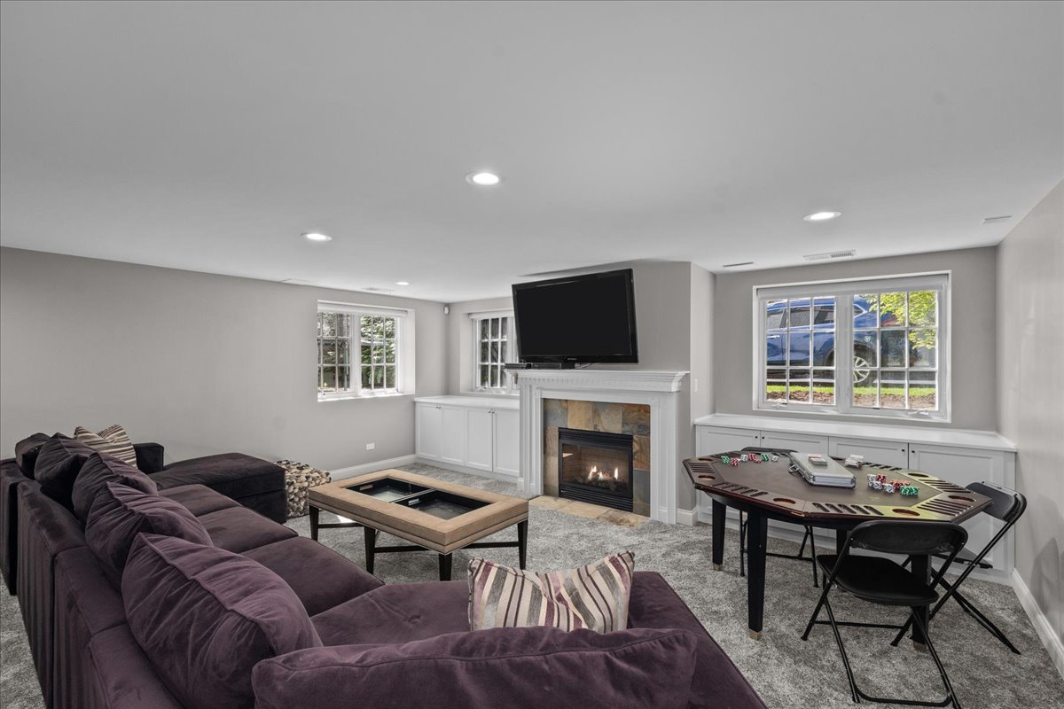 1423 Northwoods Road Deerfield, IL 60015 - Photo 23 of 39 a living room with furniture flat screen tv and a fireplace