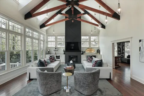 a living room with fireplace furniture and a large window