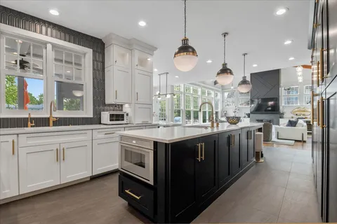 a large kitchen with a large counter top appliances and cabinets