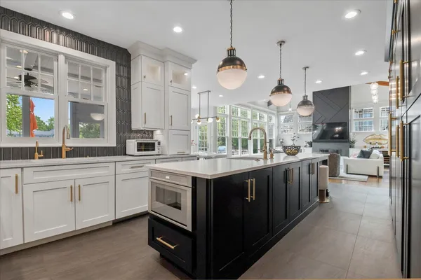 a large kitchen with a large counter top appliances and cabinets
