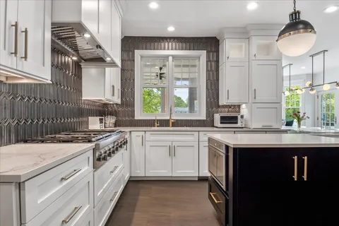 a kitchen with a sink stove and cabinets
