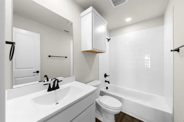 a bathroom with a sink toilet tub and shower