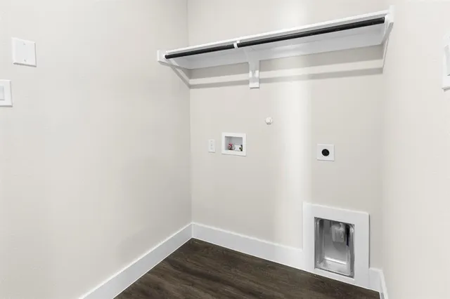 a view of a small space with wooden floor and a window