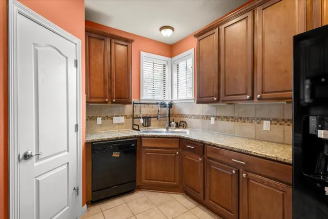 a kitchen with a sink a stove and cabinets