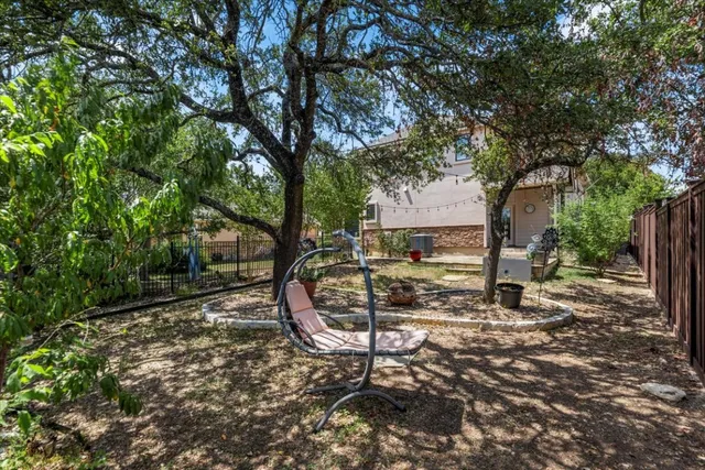 a view of a backyard with large tree