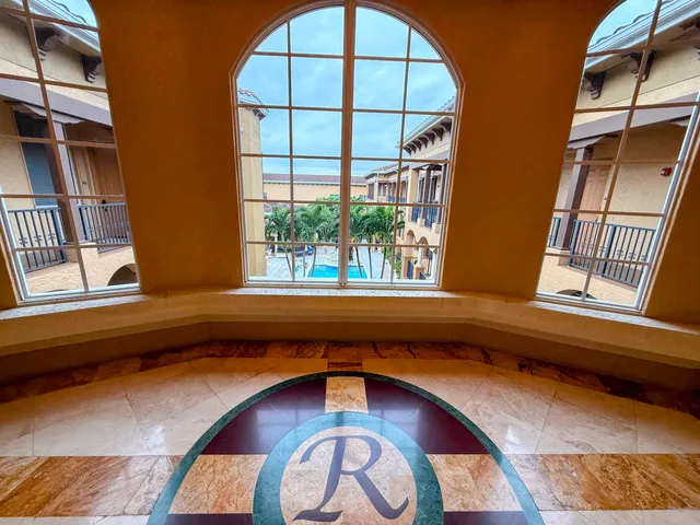 a kitchen with stainless steel appliances kitchen island granite countertop a stove and a refrigerator